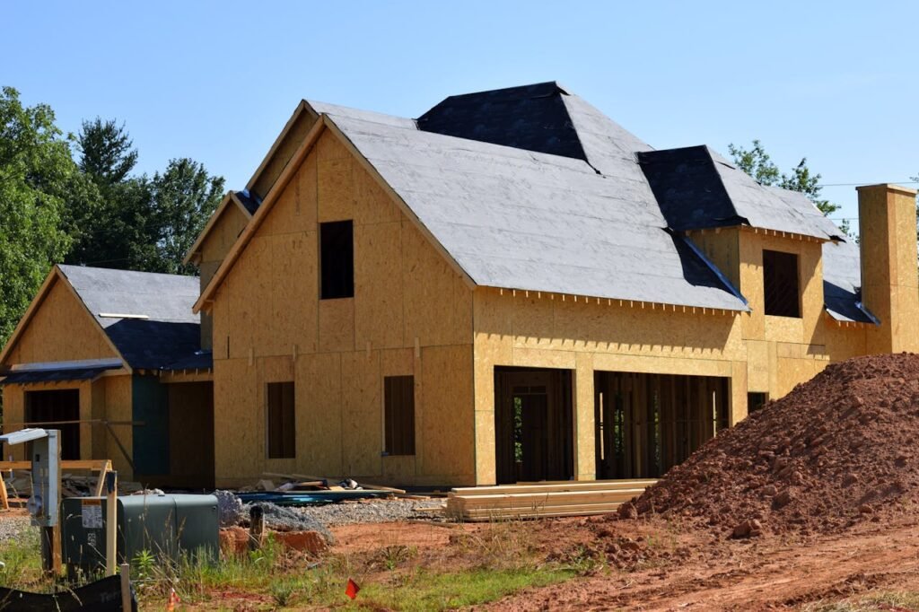 pexels-photo-209266 A partially built wooden house under construction, showcasing its progress and design in daylight.