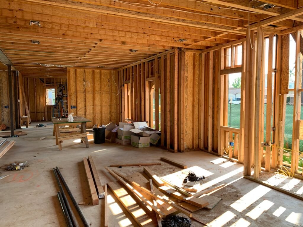 pexels-photo-4642438 Sunlit interior with wood framing, showcasing home construction progress.